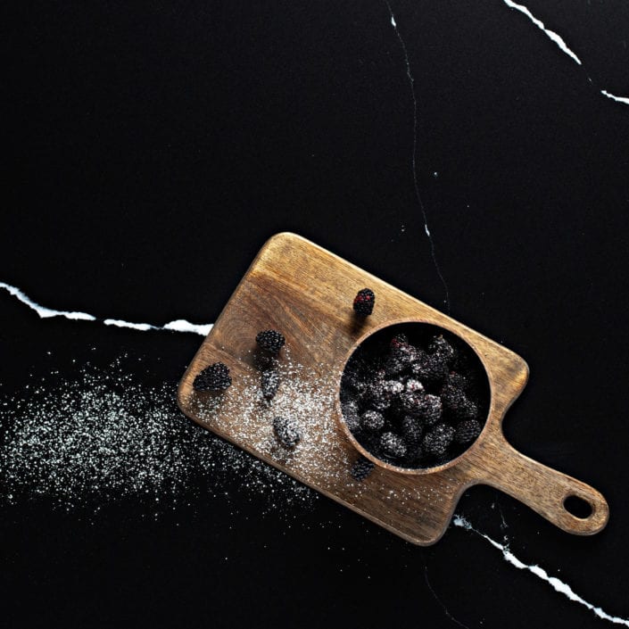 serving board with blackberries